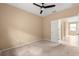 A simply decorated bedroom with carpet and a ceiling fan at 5616 Nw 39Th Ln, Ocala, FL 34482