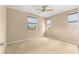 Neutral bedroom with ceiling fan, carpeted floors, and lots of natural light from three windows at 5616 Nw 39Th Ln, Ocala, FL 34482