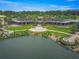Clubhouse featuring an outdoor patio, picturesque lake, and lush landscaping at 5616 Nw 39Th Ln, Ocala, FL 34482