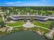 Luxury clubhouse with outdoor patio and a scenic lake view creating an inviting atmosphere at 5616 Nw 39Th Ln, Ocala, FL 34482
