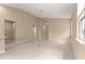 Open-concept living room features modern tile flooring and a ceiling fan for comfortable living at 5616 Nw 39Th Ln, Ocala, FL 34482