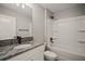 Modern bathroom features a granite vanity and a bathtub with a shower at 60 Walnut Dr, Ocala, FL 34480