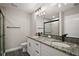Modern bathroom features a double granite vanity with a walk-in glass shower at 60 Walnut Dr, Ocala, FL 34480