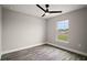 The bedroom features modern floors, neutral walls, a ceiling fan, and a bright window at 60 Walnut Dr, Ocala, FL 34480
