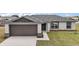 Charming home showcasing a two-car garage and neatly maintained landscaping at 60 Walnut Dr, Ocala, FL 34480
