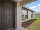 Close up of front door, showing the front windows and manicured landscaping at 60 Walnut Dr, Ocala, FL 34480
