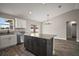 Modern kitchen features an island, stainless steel appliances, granite counters, and wood-look flooring at 60 Walnut Dr, Ocala, FL 34480