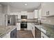 Modern kitchen with stainless steel appliances, granite counters and ample cabinet space at 60 Walnut Dr, Ocala, FL 34480