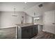 Kitchen island with granite countertop overlooks a large living area with hardwood floors at 60 Walnut Dr, Ocala, FL 34480