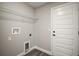 Bright laundry room featuring white trim, gray walls, and a wire rack shelf at 60 Walnut Dr, Ocala, FL 34480