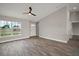 Bright living room featuring a ceiling fan, wood floors and view of the front yard at 60 Walnut Dr, Ocala, FL 34480
