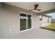 View of the outdoor patio featuring a ceiling fan and sliding glass door at 60 Walnut Dr, Ocala, FL 34480