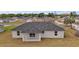 Aerial view of the home's rear exterior showing a covered patio and spacious backyard at 60 Walnut Dr, Ocala, FL 34480