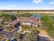 Beautiful aerial view of the community center nestled among trees and overlooking the lake with ample parking at 6376 Sw 97Th Terrace Rd, Ocala, FL 34481