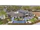 Stunning aerial view of the community center, showcasing an expansive patio, shuffleboard, and ample parking at 6376 Sw 97Th Terrace Rd, Ocala, FL 34481