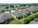Aerial view of homes in a lakeside community with well-maintained yards at 6376 Sw 97Th Terrace Rd, Ocala, FL 34481