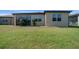 Well-maintained backyard featuring green grass, a covered patio, and a landscaped perimeter at 6376 Sw 97Th Terrace Rd, Ocala, FL 34481