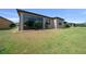 View of spacious backyard with lawn and covered patio at 6376 Sw 97Th Terrace Rd, Ocala, FL 34481