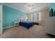 Bright bedroom featuring a blue accent wall, ceiling fan, and natural light at 6376 Sw 97Th Terrace Rd, Ocala, FL 34481
