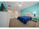 Bright bedroom with blue wall and ensuite bath at 6376 Sw 97Th Terrace Rd, Ocala, FL 34481