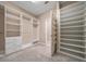 Spacious walk-in closet featuring custom shelves, drawers, and shoe racks for organized storage at 6376 Sw 97Th Terrace Rd, Ocala, FL 34481
