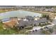 Aerial view of the community clubhouse with lake view, parking and outdoor activity area at 6376 Sw 97Th Terrace Rd, Ocala, FL 34481