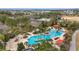 Stunning aerial view of a resort-style community pool with palm trees and plenty of lounge seating at 6376 Sw 97Th Terrace Rd, Ocala, FL 34481