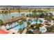 Expansive community pool surrounded by palm trees, lounge chairs and water views at 6376 Sw 97Th Terrace Rd, Ocala, FL 34481