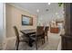 Inviting dining area with neutral tones, a rustic wooden table, and a view into the open kitchen at 6376 Sw 97Th Terrace Rd, Ocala, FL 34481