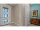 Hallway featuring a decorative glass door, neutral paint, and tile flooring at 6376 Sw 97Th Terrace Rd, Ocala, FL 34481