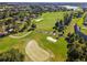 Aerial shot of the lush golf course, featuring manicured greens and picturesque sand traps at 6376 Sw 97Th Terrace Rd, Ocala, FL 34481