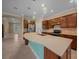An open kitchen offers an oversized island, stainless appliances, and wood cabinetry at 6376 Sw 97Th Terrace Rd, Ocala, FL 34481