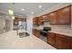 A modern kitchen with dark wood cabinets, stainless appliances, and a large island at 6376 Sw 97Th Terrace Rd, Ocala, FL 34481