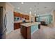 A spacious kitchen with an island, wooden cabinets, and stainless steel appliances at 6376 Sw 97Th Terrace Rd, Ocala, FL 34481