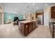 Open concept: Kitchen with island flows into living space, perfect for entertaining guests at 6376 Sw 97Th Terrace Rd, Ocala, FL 34481