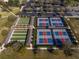 Aerial view of pickleball and bocce courts, surrounded by trees and parking at 6376 Sw 97Th Terrace Rd, Ocala, FL 34481