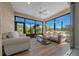 A sunroom with wood floors, plenty of natural light, and views of lush landscaping at 6376 Sw 97Th Terrace Rd, Ocala, FL 34481