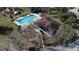 Aerial shot showcases a pool and recreational facility with mature trees, a nice addition to the community at 660 Silver Pass, Ocala, FL 34472