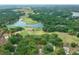 Aerial view showcasing the property, lake, golf course, and surrounding landscape at 660 Silver Pass, Ocala, FL 34472