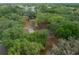 A lakefront home features mature trees and is set back from the water for a private, wooded homesite at 660 Silver Pass, Ocala, FL 34472