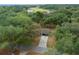 Aerial perspective of the home nestled among lush greenery and mature trees at 660 Silver Pass, Ocala, FL 34472
