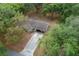 Aerial view showcases a long driveway, mature trees, large homesite, and the home's setting at 660 Silver Pass, Ocala, FL 34472