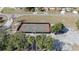 An aerial shot displays the basketball court surrounded by a parking lot and green trees at 660 Silver Pass, Ocala, FL 34472