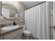Cozy bathroom with a shower, modern sink, decorative mirror, and neutral-toned walls at 660 Silver Pass, Ocala, FL 34472