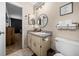 Bathroom with updated vanity, sink, round mirror, and a 'take a seat' sign at 660 Silver Pass, Ocala, FL 34472