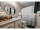 Bathroom with updated vanity, sink, a round mirror and shower with curtain at 660 Silver Pass, Ocala, FL 34472