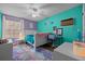 Bright bedroom with teal and purple walls, a ceiling fan, a colorful rug, and natural light from the window at 660 Silver Pass, Ocala, FL 34472