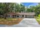 Charming single-story home features a long driveway, attached carport, and an inviting front entrance at 660 Silver Pass, Ocala, FL 34472