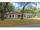 Charming single-story home with white shutters, an attached carport, and a well-maintained front lawn at 660 Silver Pass, Ocala, FL 34472