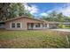 Charming single-story home with a well-manicured lawn, covered porch, and attached carport at 660 Silver Pass, Ocala, FL 34472